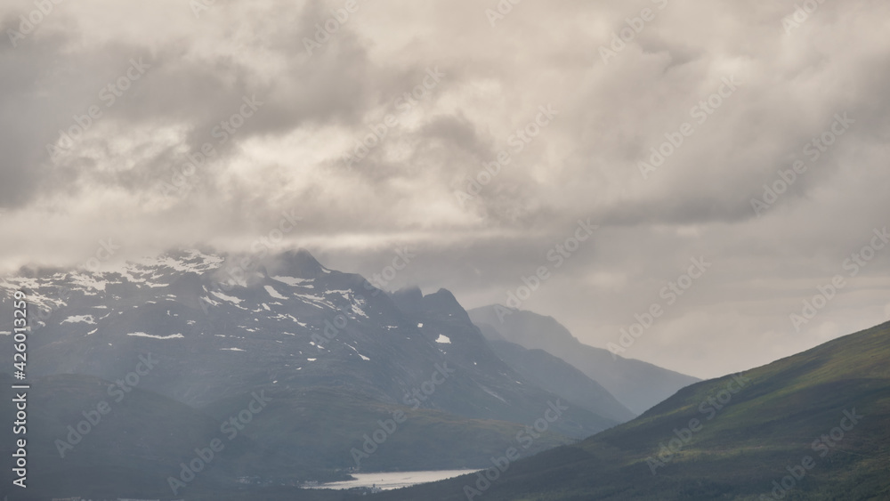 Obraz premium Scenic view of clouds and mountains near Tromso