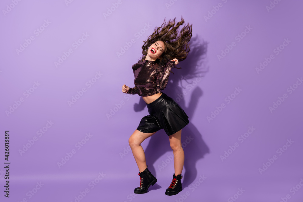 Full length body size view of cool pretty cheerful dreamy girl dancing having fun clubbing isolated over bright violet color background Full length body size view of cool pretty cheerful dreamy girl dancing having fun clubbing isolated over bright violet color background