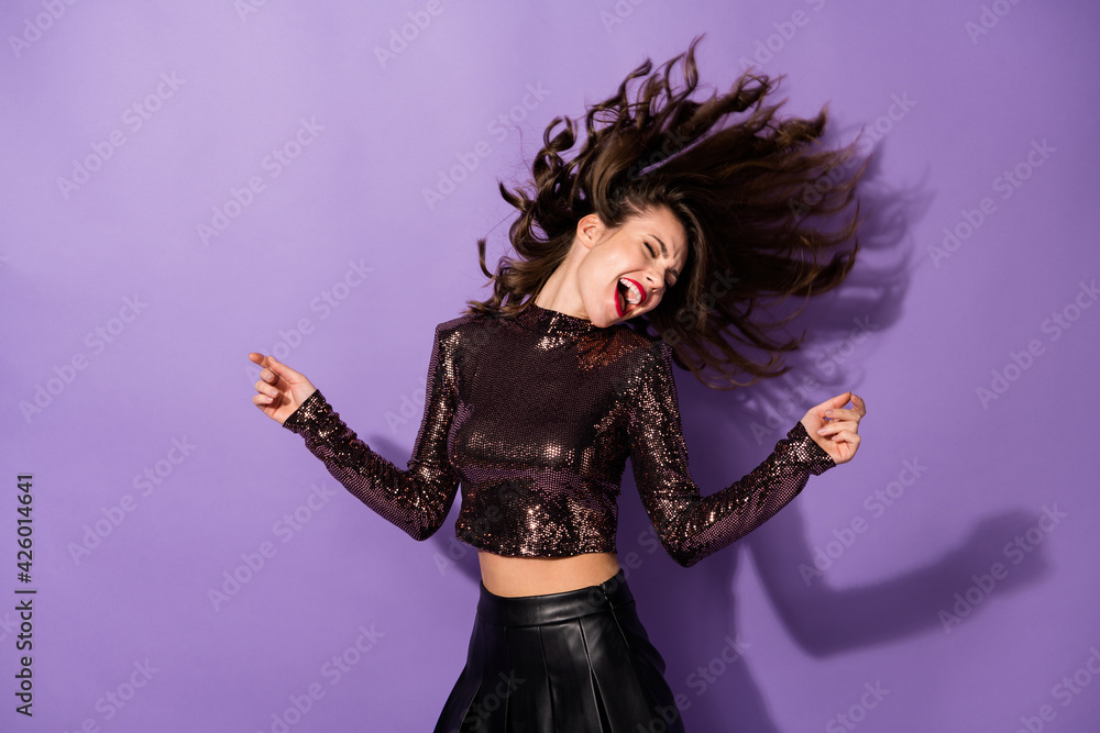 Portrait of gorgeous glamorous cheerful dreamy girl dancing having fun clubbing isolated over bright violet color background