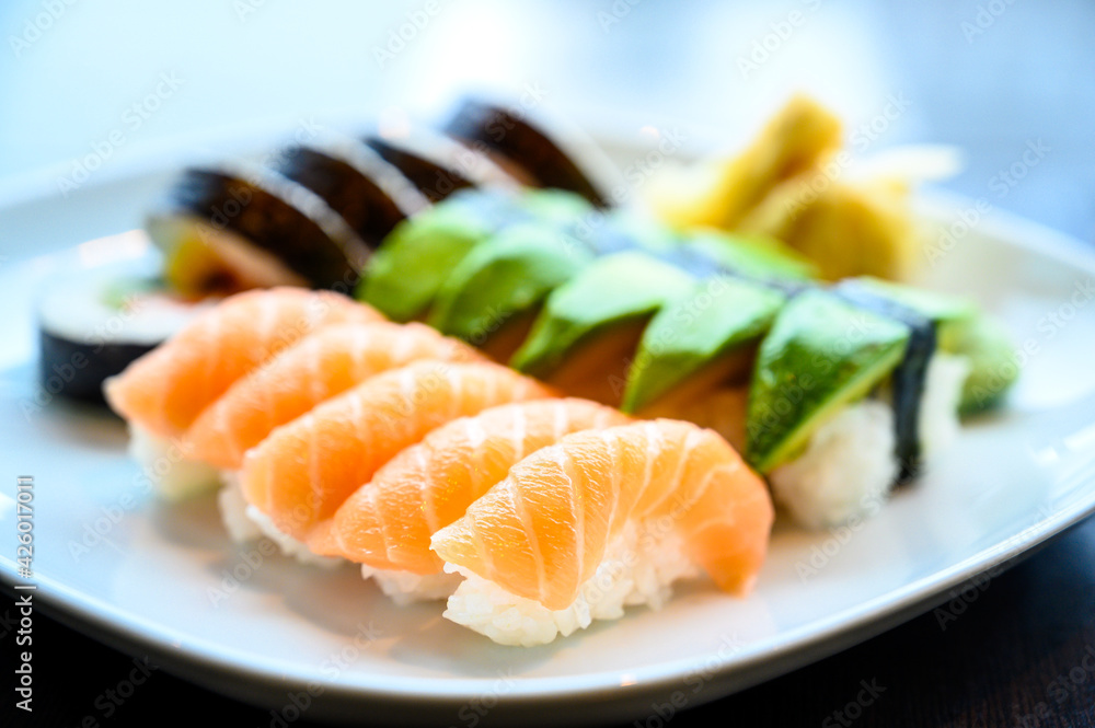 Assorted sushi set of sushi rolls and nigiri on a white plate Assorted sushi set of sushi rolls and nigiri on a white plate