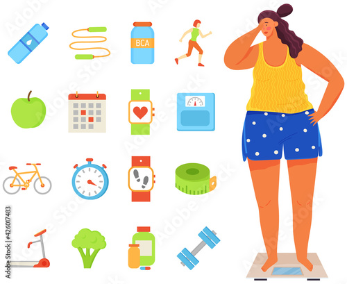 Young woman stands on scales and weights. Calorie counter symbols, pedometer, sports equipment