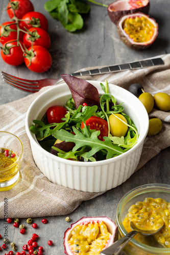 Salad maracuja tomatoes pepper on green background. Organic food.