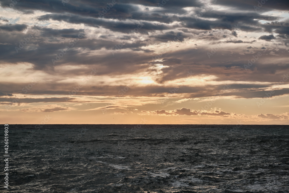Scenic view of clouds over the sea during sunset Scenic view of clouds over the sea during sunset