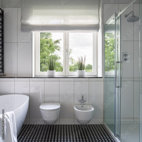 Spacious bathroom with bathtub and shower