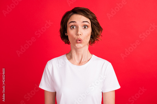 Portrait of attractive amazed girl news reaction pout lips stupor isolated over bright red color background