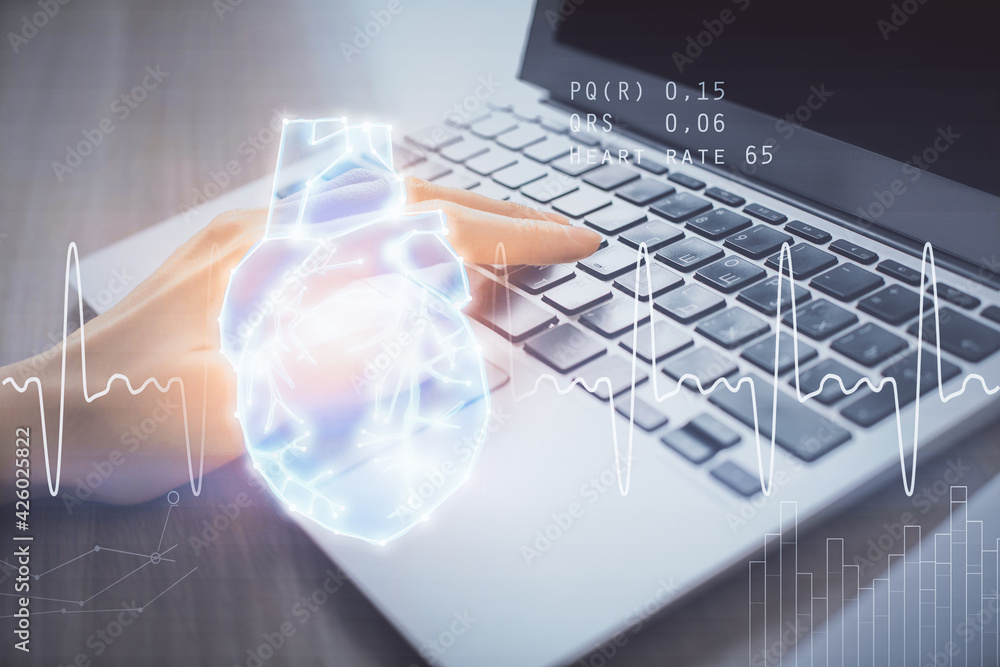 Double exposure of woman hands typing on computer and heart hologram drawing. Education concept. Double exposure of woman hands typing on computer and heart hologram drawing. Education concept.