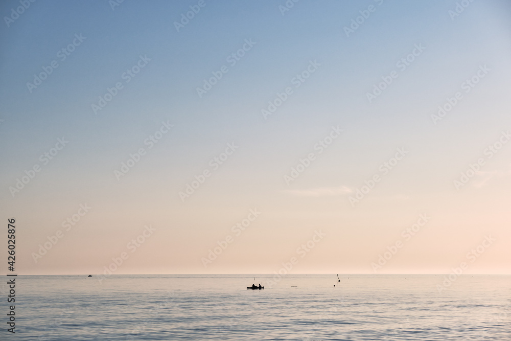 Scenic view of  some fishermen  during a beautiful sunrise 