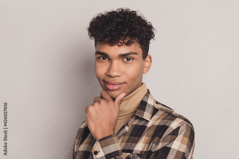 Photo portrait of young curly boy thoughtful clever got idea touching chin isolated on grey color background