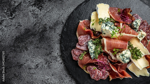 Fototapeta Naklejka Na Ścianę i Meble -  Slices of delicious spanish sausage salami. Antipasto platter for vine. Long banner format, top view