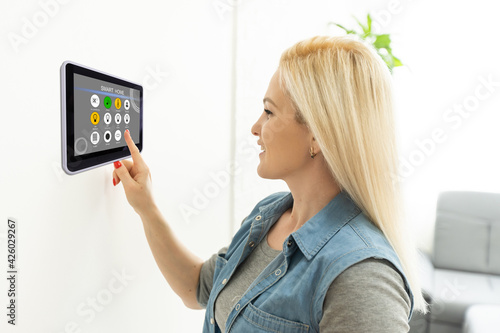 Woman using tablet in wall Smart House