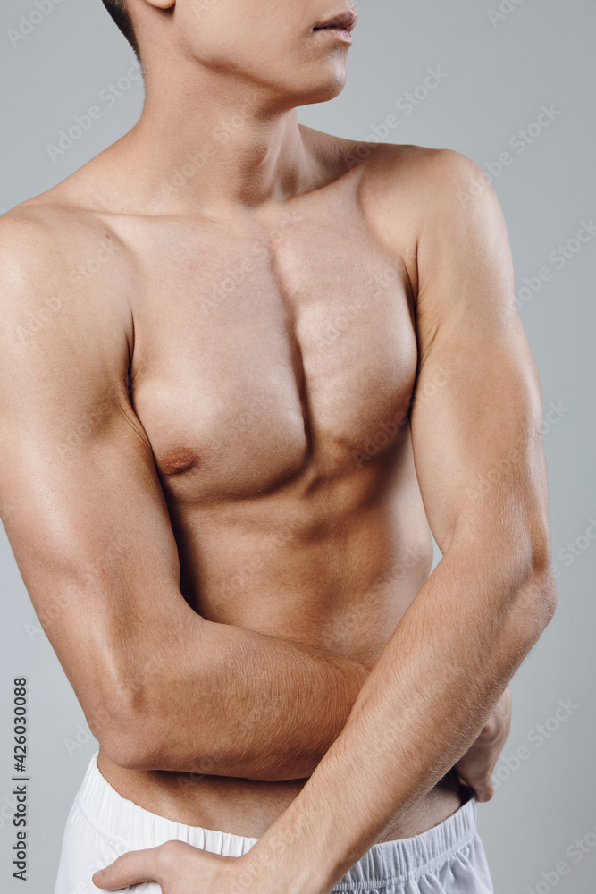 Fototapeta premium bodybuilder with pumped up abs and arm muscles biceps athlete