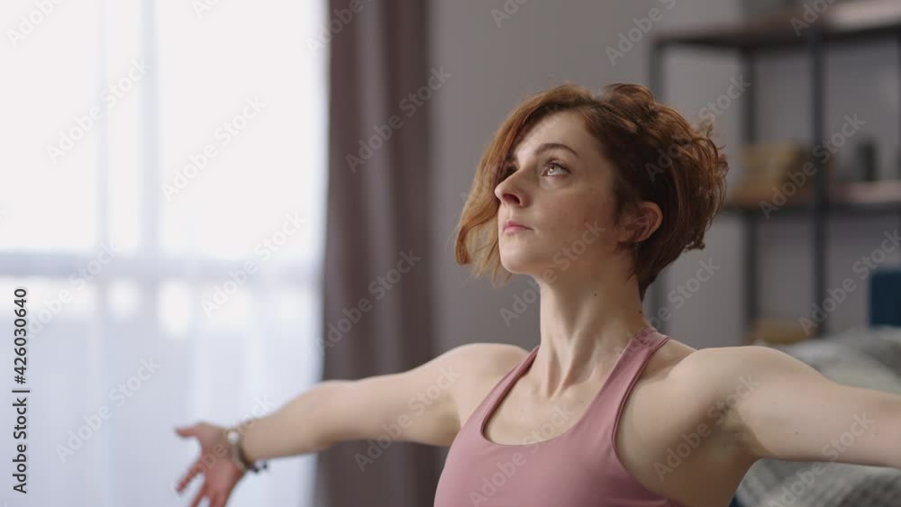 morning exercises and workout for stretching, woman is sitting on floor in apartment, doing exercises for stretching morning exercises and workout for stretching, woman is sitting on floor in apartment, doing exercises for stretching