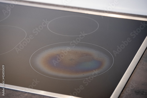 Iridescent Burnt Metal Traces in a Ceramic Glass Induction Stove photo