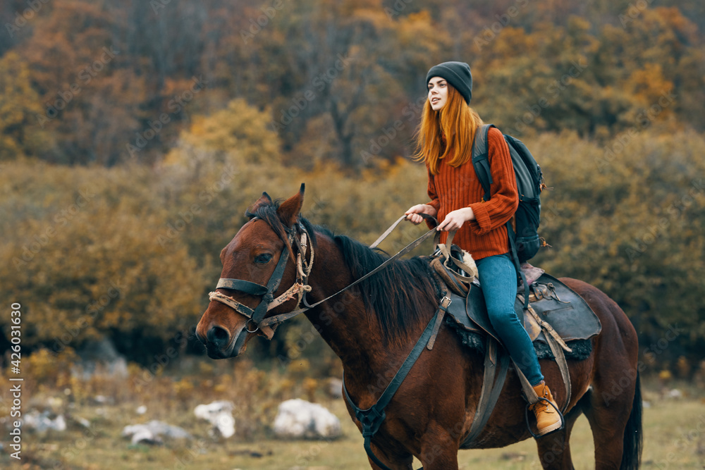 woman riding a horse on nature mountains travel adventure woman riding a horse on nature mountains travel adventure