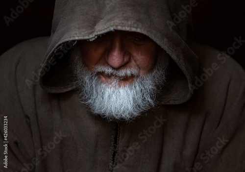 Medieval face of a poor beggar or monk photo