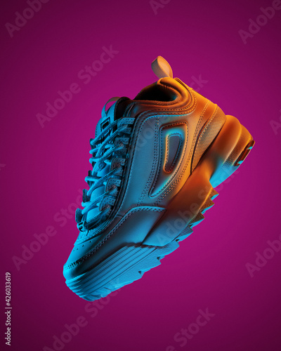 floating fashion sneakers in neon lights photo
