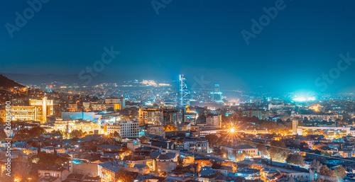Tbilisi, Georgia. Elevated Rooftop View In Night Illuminations. Georgian Capital Skyline Cityscape. Panorama, Panoramic Evening View
