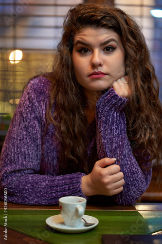 Young woman having cofee in a restaurant photo