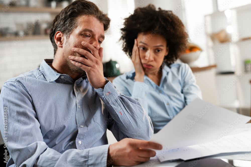 Young couple preparing bills to pay. Stressed woman and man having financial problems. Young couple preparing bills to pay. Stressed woman and man having financial problems.