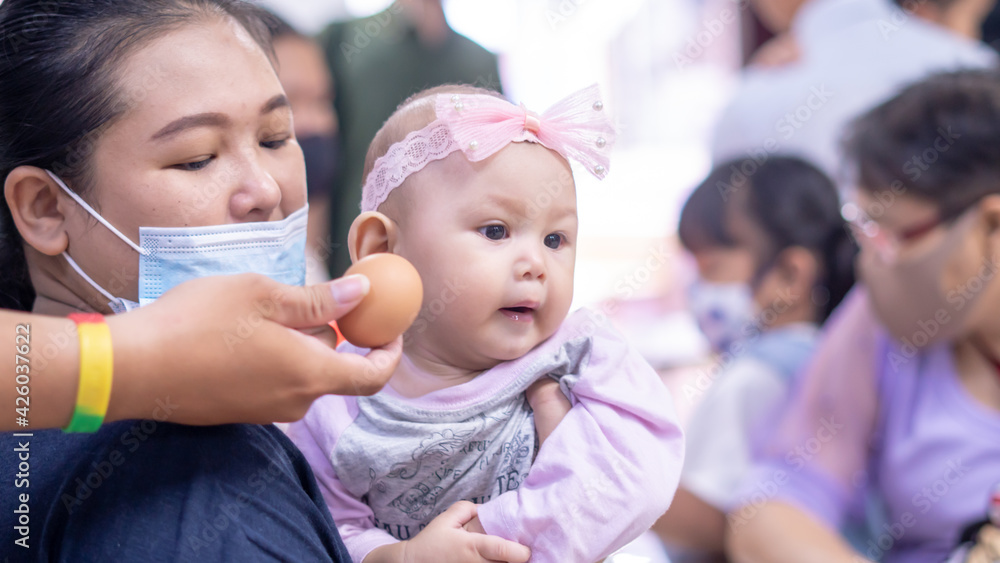 Asian Baby Girl Playing with an Easter Egg Asian Baby Girl Playing with an Easter Egg