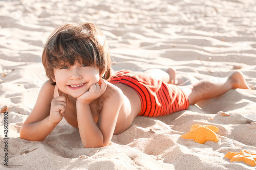 Cute little boy lying on se...