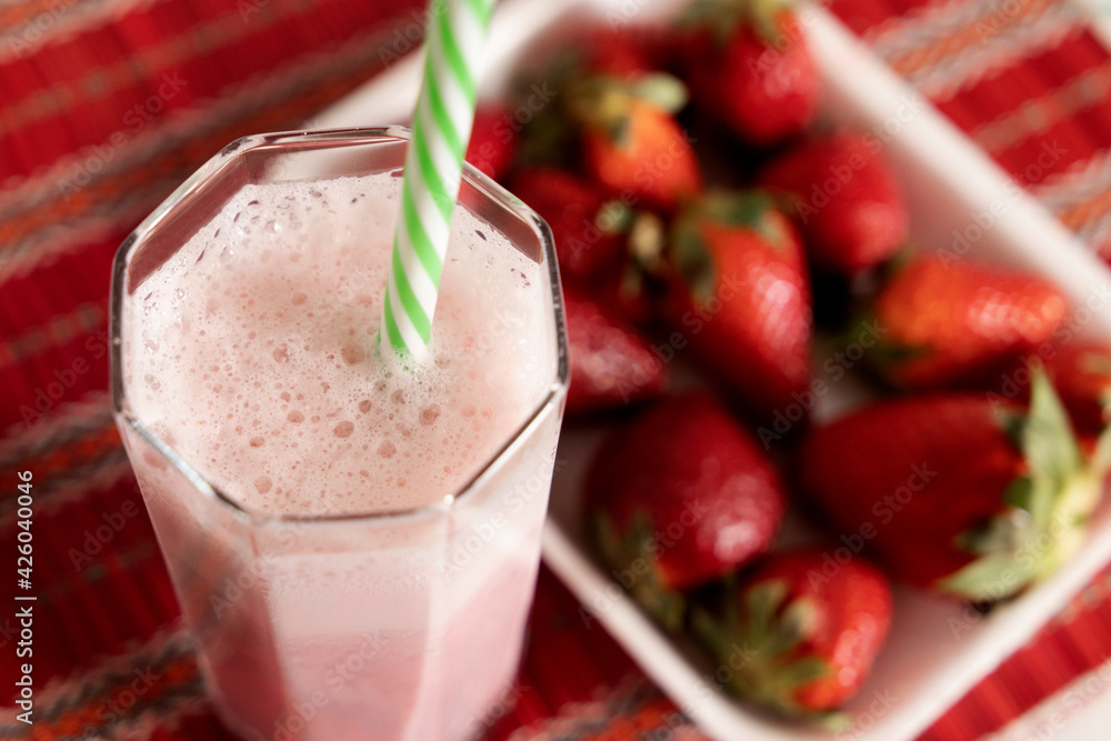 strawberry milkshake in the foreground and unfocused background strawberry milkshake in the foreground and unfocused background