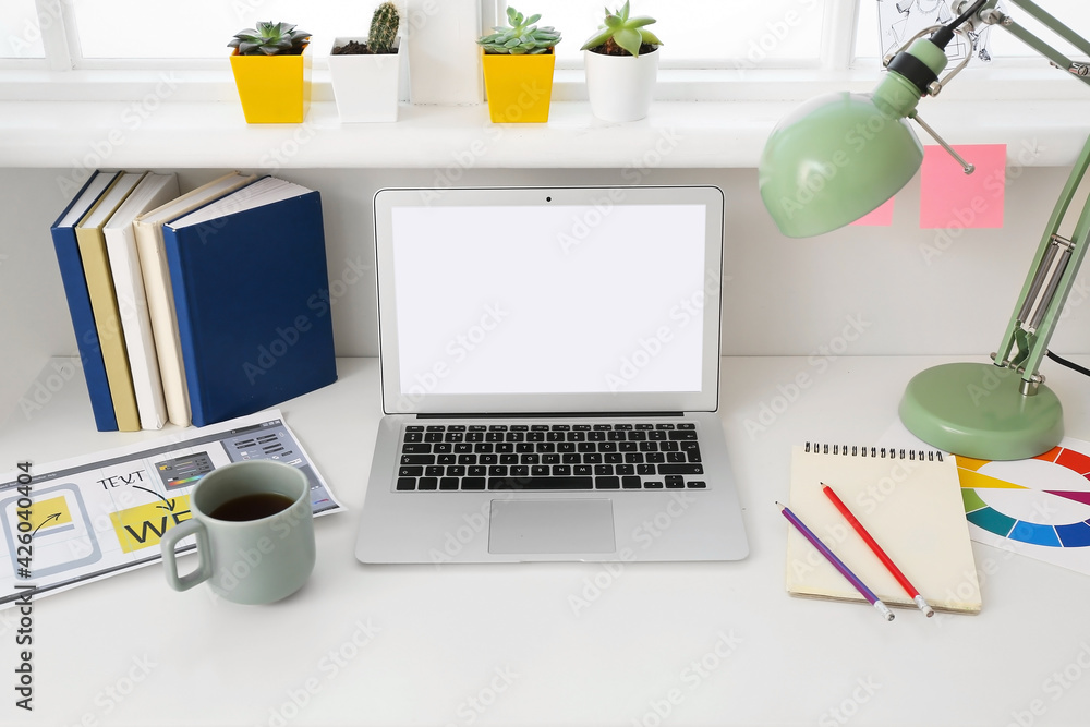 Stylish workplace with laptop in office Stylish workplace with laptop in office