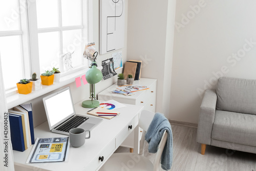 Stylish workplace with laptop in office © Pixel-Shot