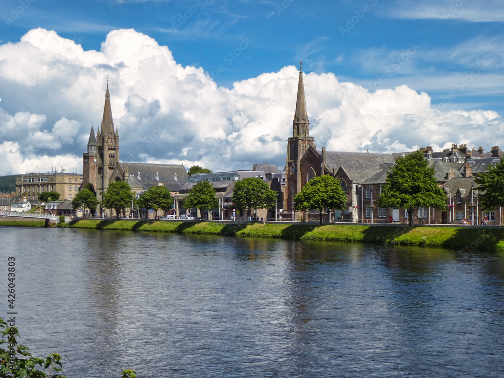 Fototapeta premium View along the bank of the River Ness with St. Columba High Church and Free North Church in Inverness, Scotland.