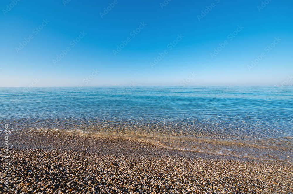 Calm morning sea. Small waves in calm conditions. Sea background