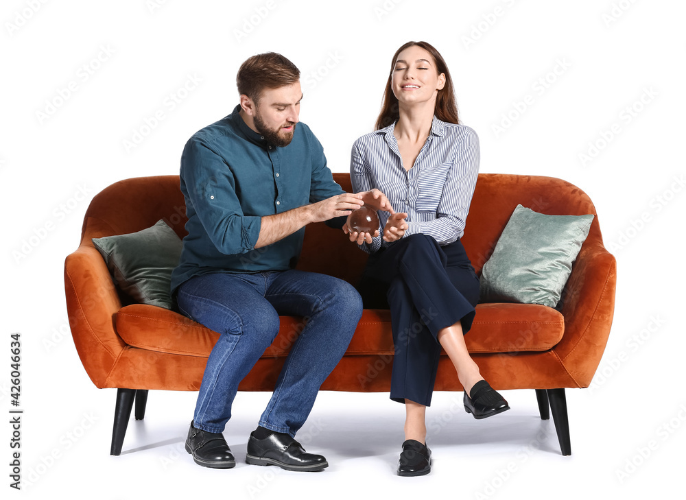 Young couple trying to read their future on white background Young couple trying to read their future on white background
