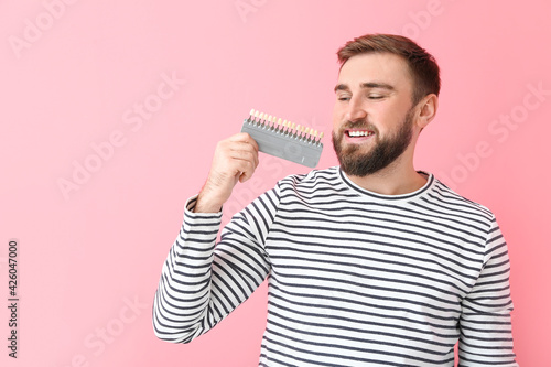 Young man with teeth color ...