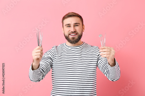 Young man with dental tools...