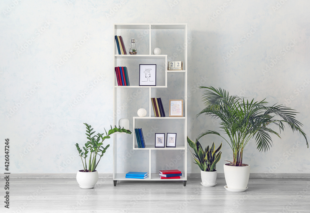 Modern interior with shelf unit and books in room - obrazy, fototapety, plakaty 