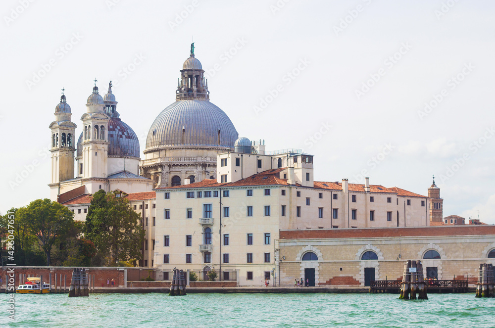 The Basilica Di Santa Maria Della Salute, view from the the Grand Canal in Venice, Italy. Italian buildings cityscape. Famous romantic city on water