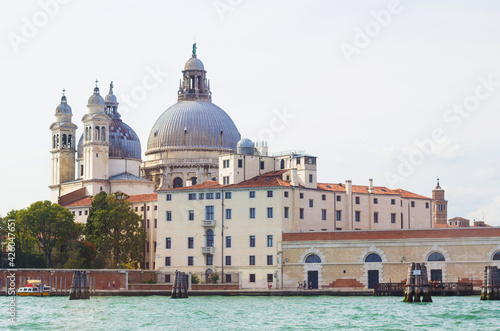 The Basilica Di Santa Maria Della Salute, view from the the Grand Canal in Venice, Italy. Italian buildings cityscape. Famous romantic city on water © Blumesser