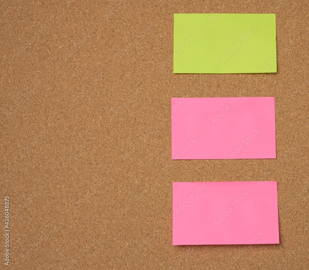 multicolored paper sticks are glued to the brown cork board multicolored paper sticks are glued to the brown cork board
