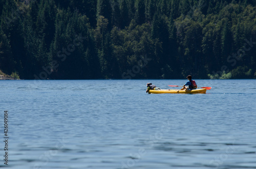 kayaking, two people paddling on lake with mountain © Lautaro