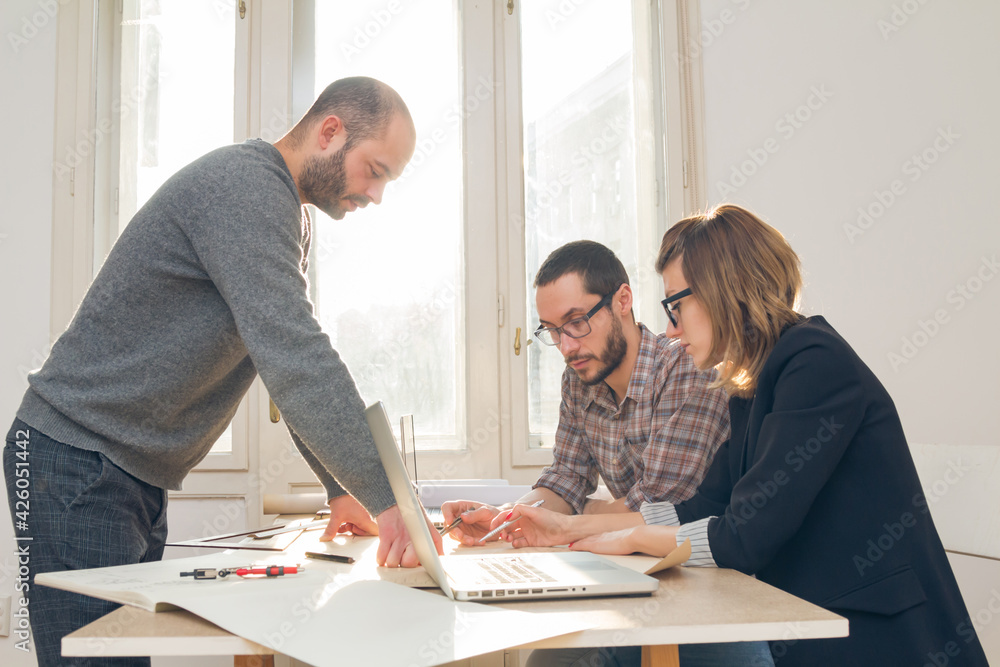 Three colleagues working from home on a project. Three colleagues working from home on a project.