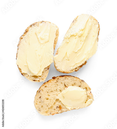 Slices of fresh bread with butter on white background