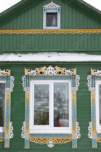 Ornamental window with carved frameson vintage wooden rural house in Nerekhta town, Kostroma region, Russia. Building facade. Russian traditional national folk style in architecture. Russan landmark photo