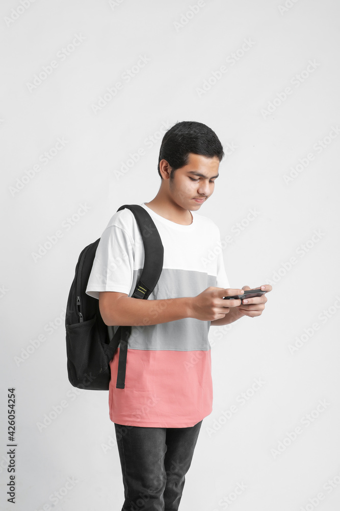 indian college student using smartphone on white background. indian college student using smartphone on white background.
