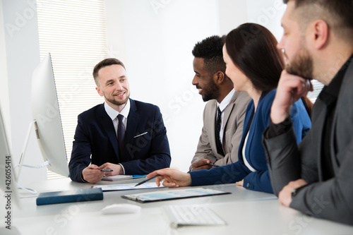 Wallpaper Mural Group of multi-ethnic business people sitting around the office desk and discussing the project Torontodigital.ca