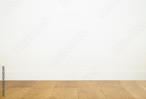 Empty room interior with white wall background and wooden floor. Empty white wall