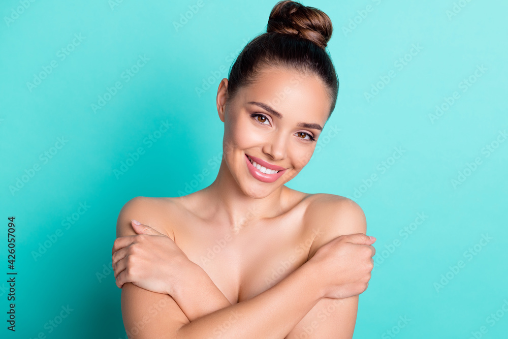 Portrait of attractive trendy cheerful girl hugging herself freshness scrub clean skin isolated over bright teal turquoise color background Portrait of attractive trendy cheerful girl hugging herself freshness scrub clean skin isolated over bright teal turquoise color background