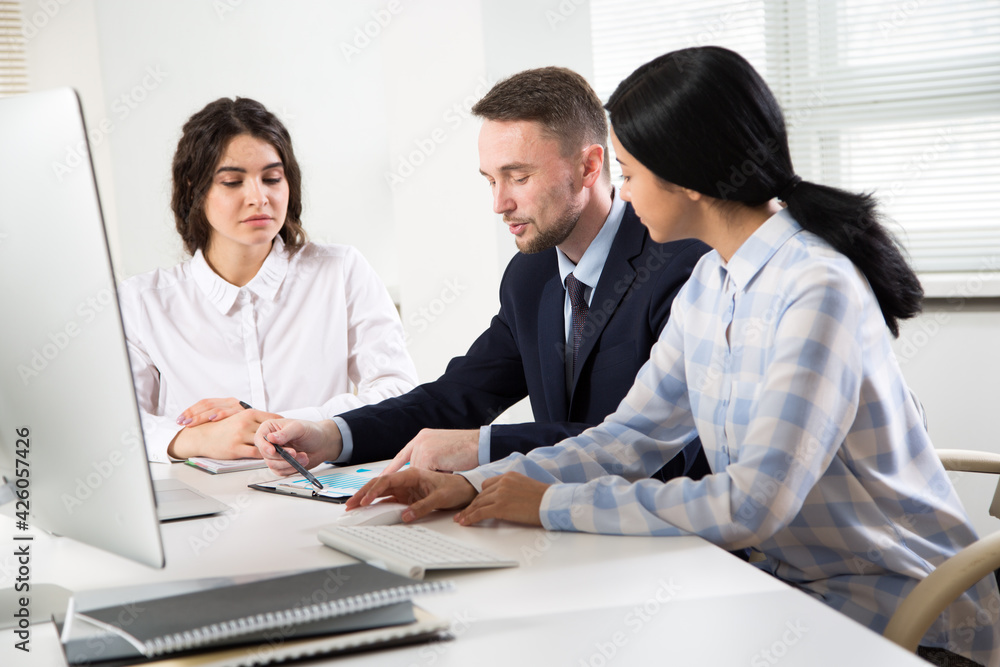 Businessman explains to colleagues a new project in the office Businessman explains to colleagues a new project in the office