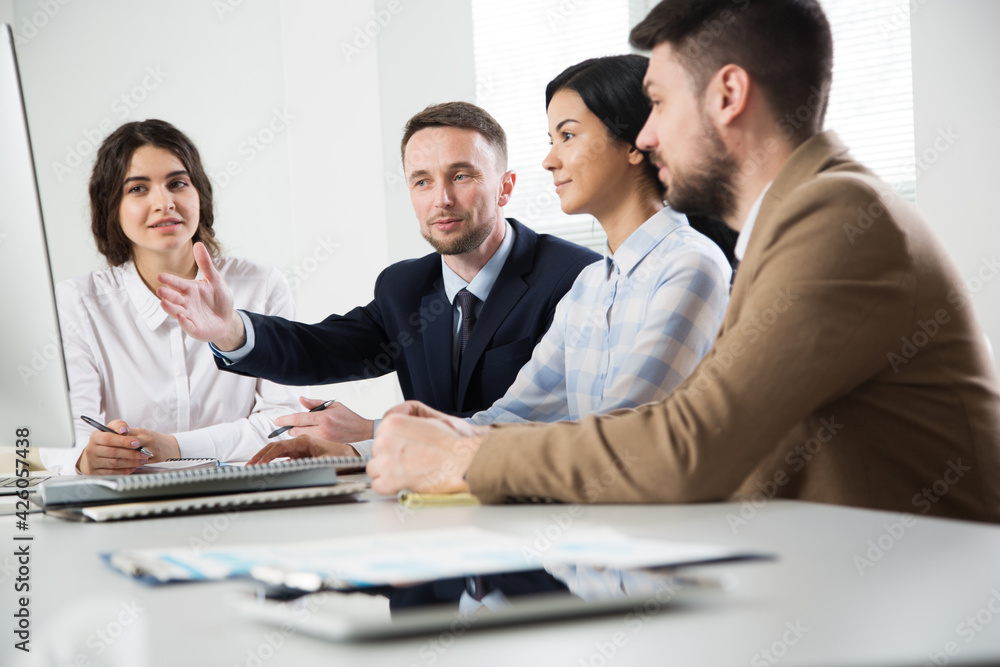 Businessman explains to colleagues a new project in the office Businessman explains to colleagues a new project in the office