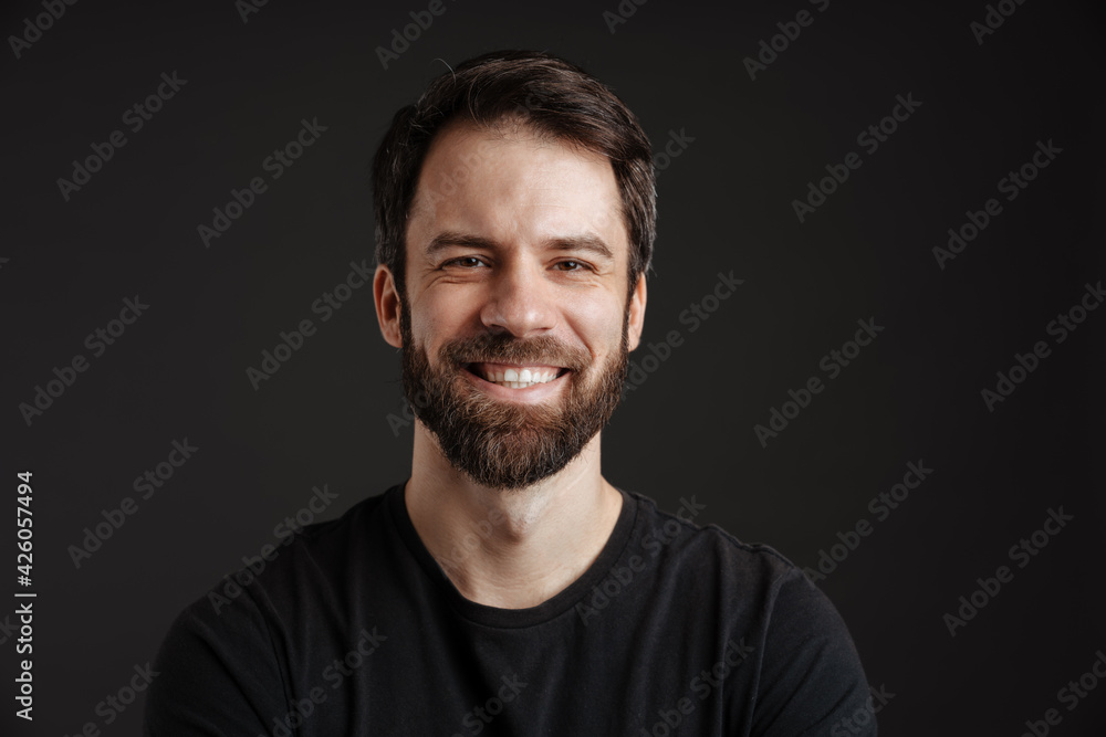 Bearded brunette man smiling and looking at camera