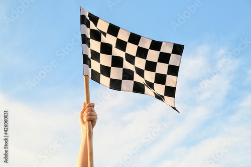 Woman with racing flag outdoors © Pixel-Shot
