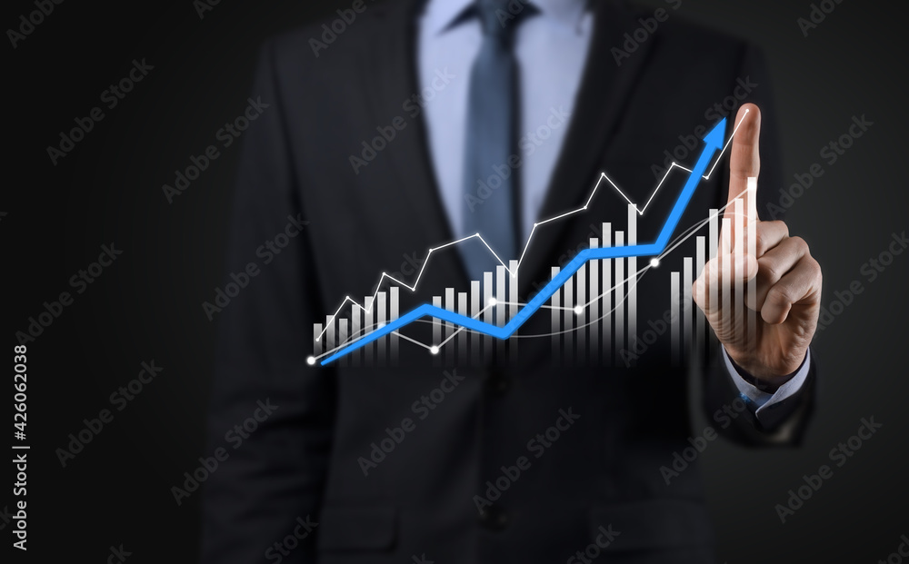 Business man holding holographic graphs and stock market statistics gain profits. Concept of growth planning and business strategy. Display of good economy form digital screen. Business man holding holographic graphs and stock market statistics gain profits. Concept of growth planning and business strategy. Display of good economy form digital screen.